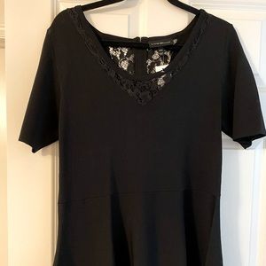 Black top with lace trim and zipper back.